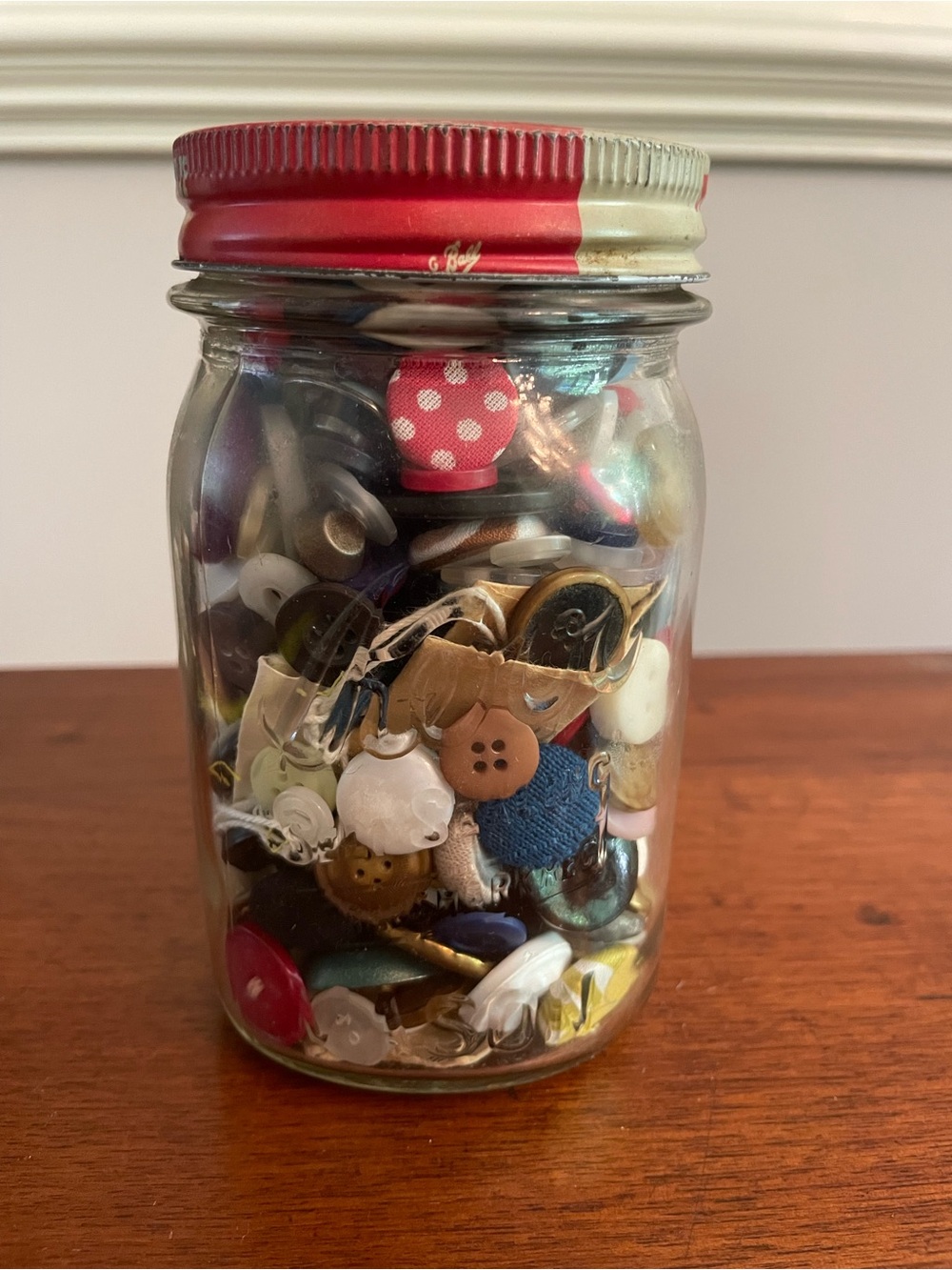 Vintage Glass Jar with Kraft Mustard Lid filled with various aged buttons